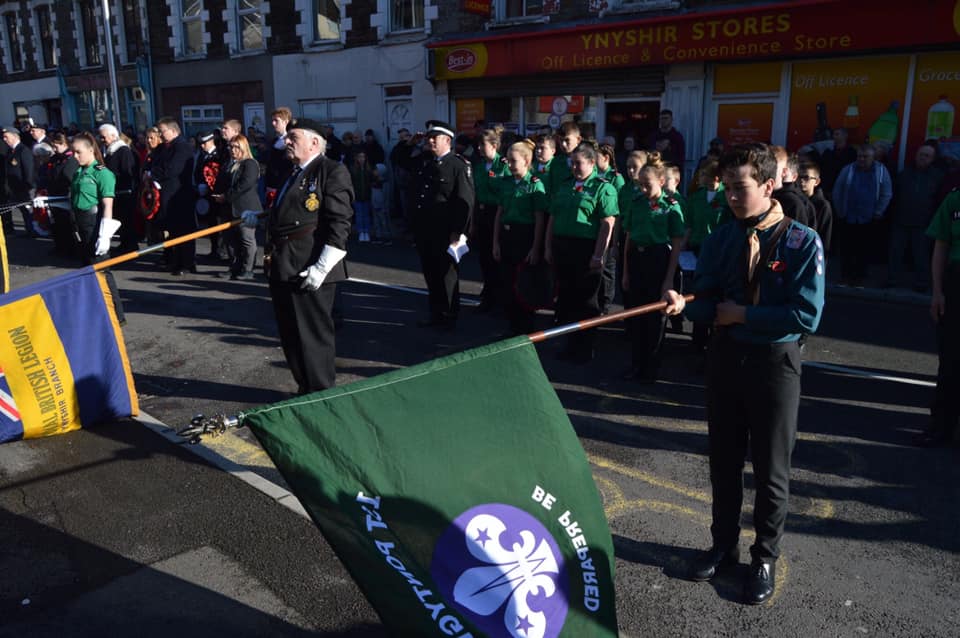 Remembrance Day Photo, showing Scouts and ex-service man with lowered flags 